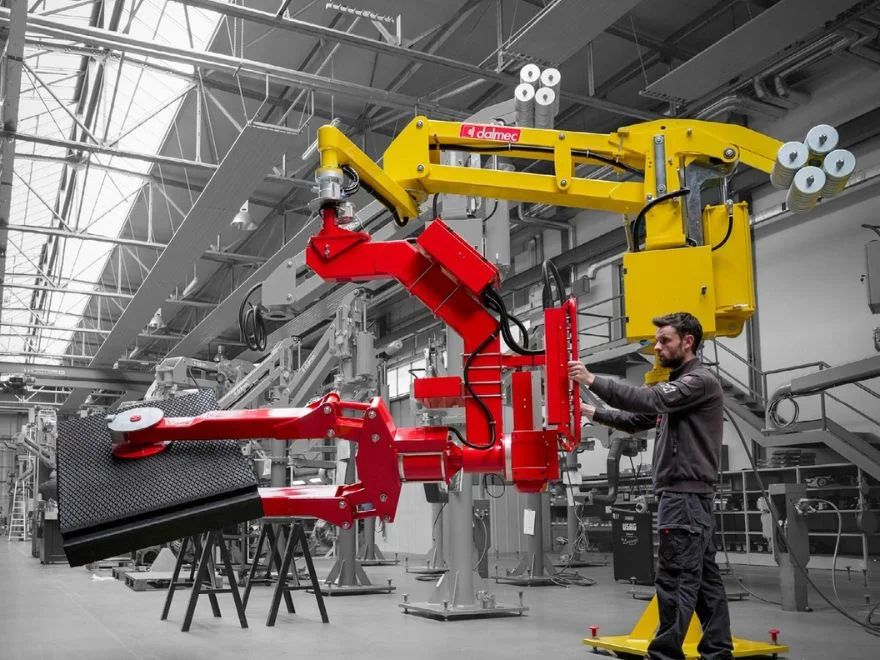Operator using a Dalmec manipulator to position a heavy industrial component safely.