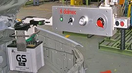 Dalmec manipulator with custom gripper handling a GS automotive battery on a vehicle assembly line