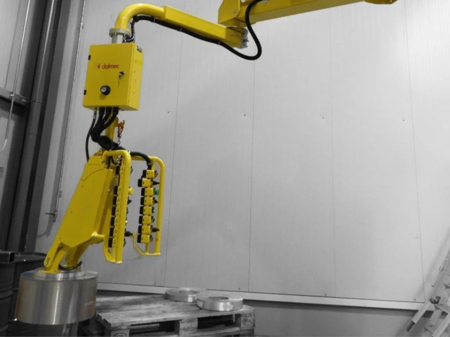 Dalmec manipulator with multi-finger gripping tool lifting a stack of aluminium rolls from a pallet.