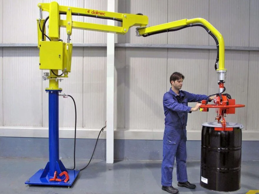 Dalmec column-mounted pneumatic industrial manipulator with drum gripping tooling handling a 200L steel drum in an Australian industrial facility, operated by a single worker