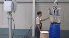 Dalmec drum handling manipulator lifting an industrial drum for safe handling of oils and process chemicals in mining.