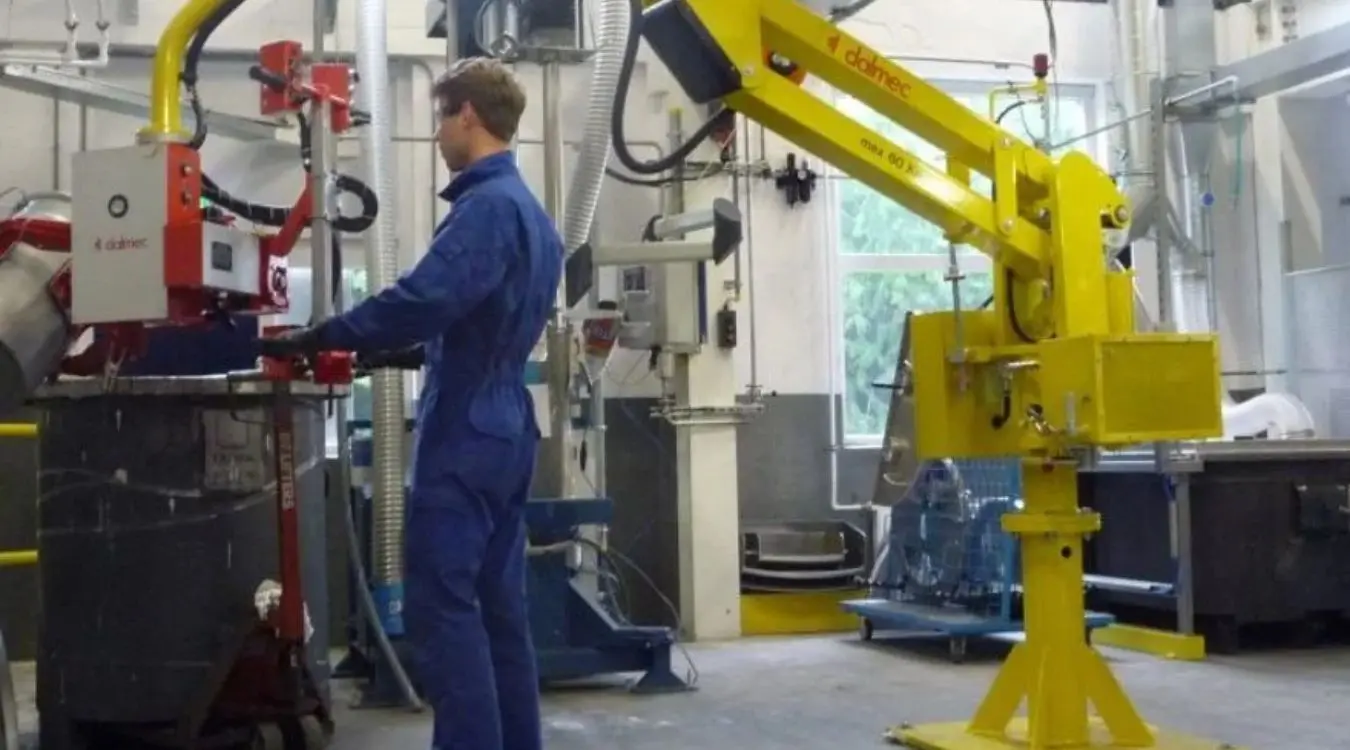 "Dalmec pneumatic manipulator lifting and tilting an industrial drum for safe handling of oils, lubricants and process chemicals in a mining facility.