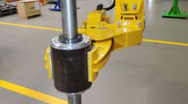 Dalmec custom manipulator lifting and positioning an industrial hose for safe handling in mining operations.
