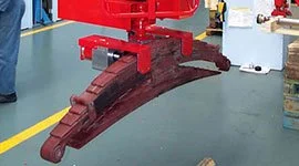 Dalmec manipulator gripper holding a heavy leaf spring component in a mechanical industry facility