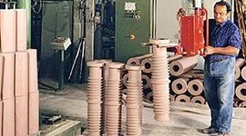 Dalmec manipulator handling ceramic building products including columns and bricks in a ceramic manufacturing facility