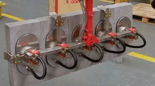 Dalmec custom vacuum suction cup gripping frame handling multiple large concrete building panels simultaneously in a construction products facility