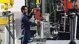 Dalmec manipulator handling air conditioner units on an electromechanical assembly line, allowing precise placement by a single operator