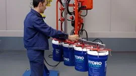 Dalmec manipulator with multi-hook gripping tool simultaneously lifting multiple food-grade pails in a food and beverage facility