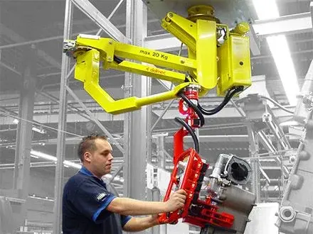 Dalmec Partner Standard manipulator with custom gripping tool handling an engine component on an assembly line, operated effortlessly by a single worker