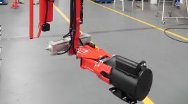 Dalmec pneumatic manipulator lifting an industrial pump for safe handling during mining equipment maintenance.