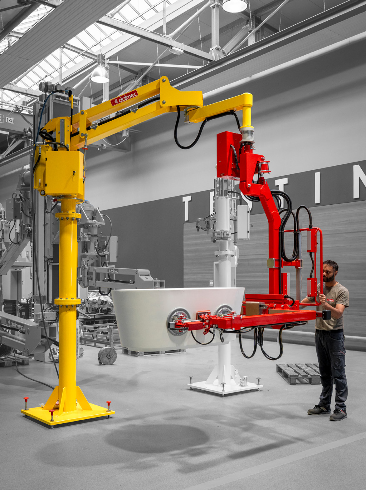 Dalmec custom manipulator handling a large bathware component with vacuum gripping technology.