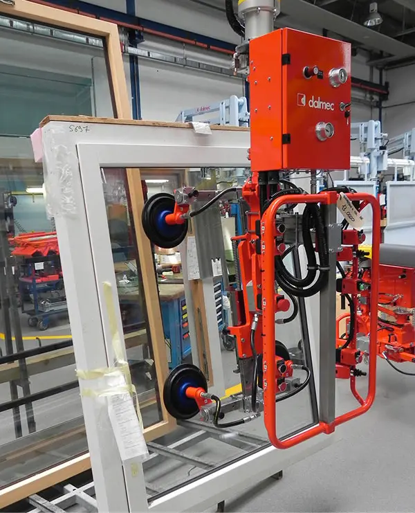 Dalmec pneumatic manipulator lifting a door panel safely during manufacturing and assembly.