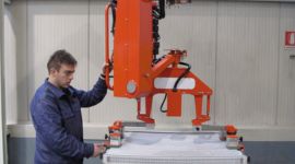 Dalmec manipulator handling engineered wood products for safe lifting and precision positioning in manufacturing.