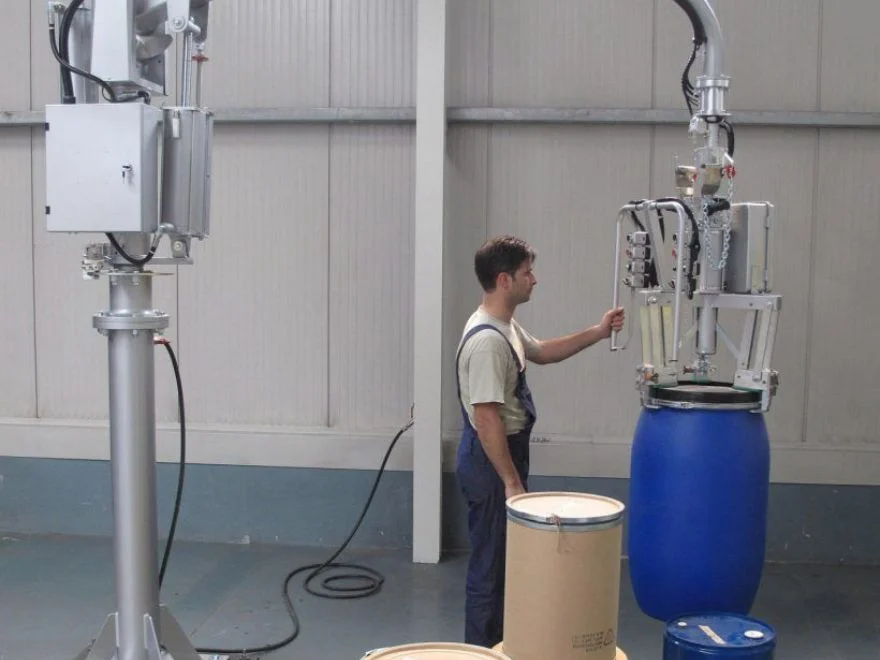 Dalmec industrial manipulator transferring heavy drums without manual lifting.