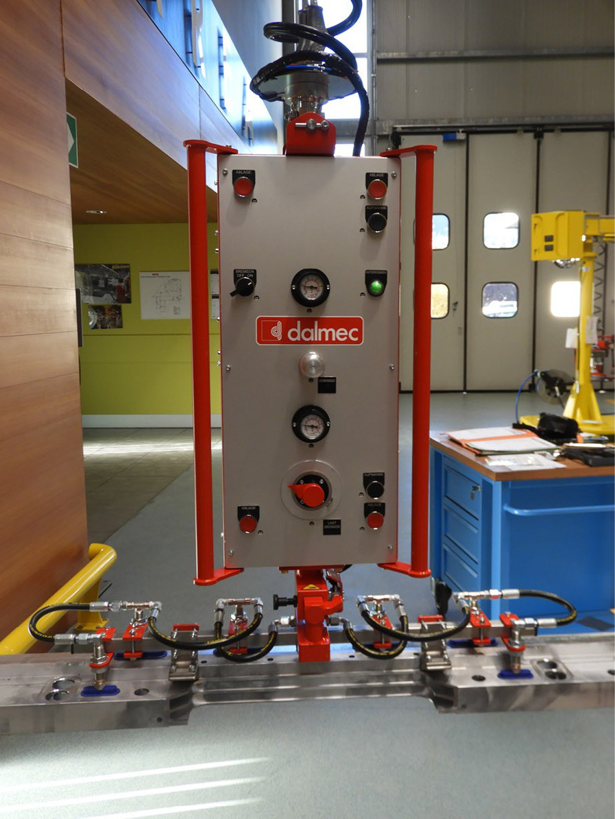 Dalmec industrial manipulator lifting long goods securely to improve workplace safety and efficiency.