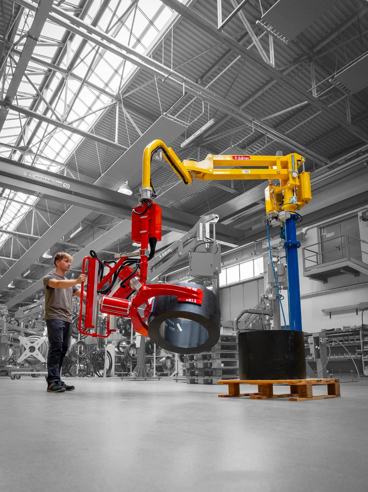 Dalmec pneumatic manipulator lifting and rotating a heavy rubber ring safely.