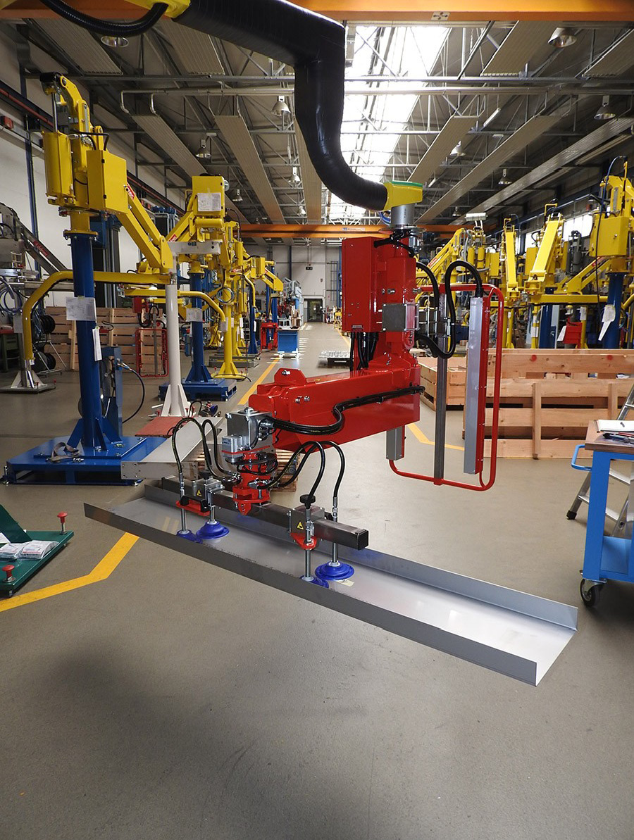 Dalmec industrial manipulator lifting a long steel profile using vacuum technology for ergonomic material handling.