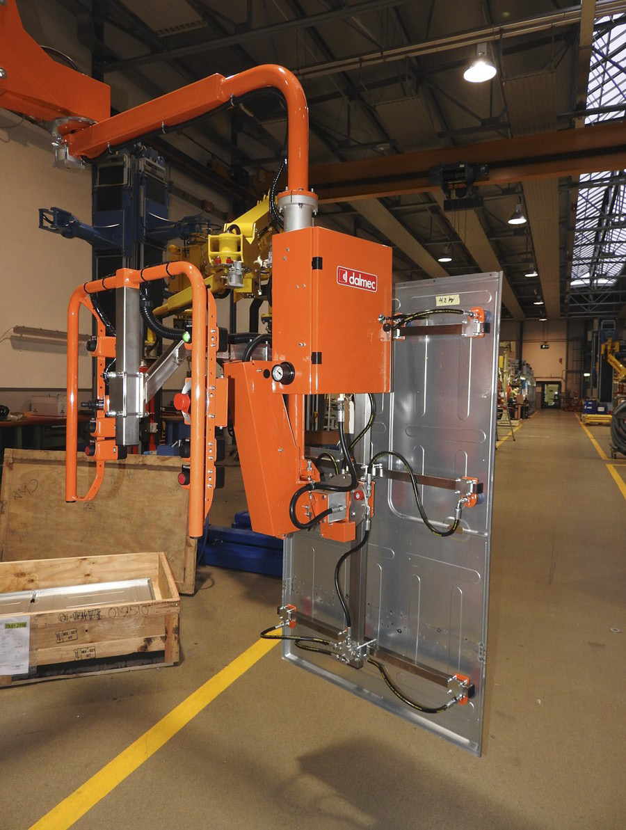 Dalmec manipulator lifting and rotating a fabricated metal door panel for safe production handling.