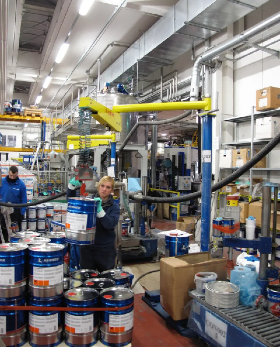 Dalmec ergonomic manipulator positioning paint products during production and packaging processes.