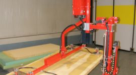 Dalmec vacuum manipulator lifting plywood sheets for precise and ergonomic material handling in timber manufacturing.
