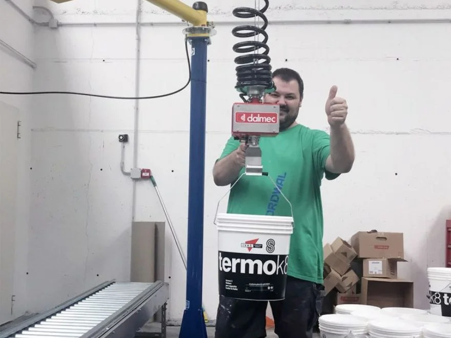 Dalmec pneumatic manipulator lifting and handling industrial pails safely.