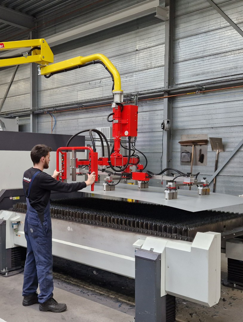 Dalmec ergonomic manipulator handling large sheet metal components in a steel fabrication facility.