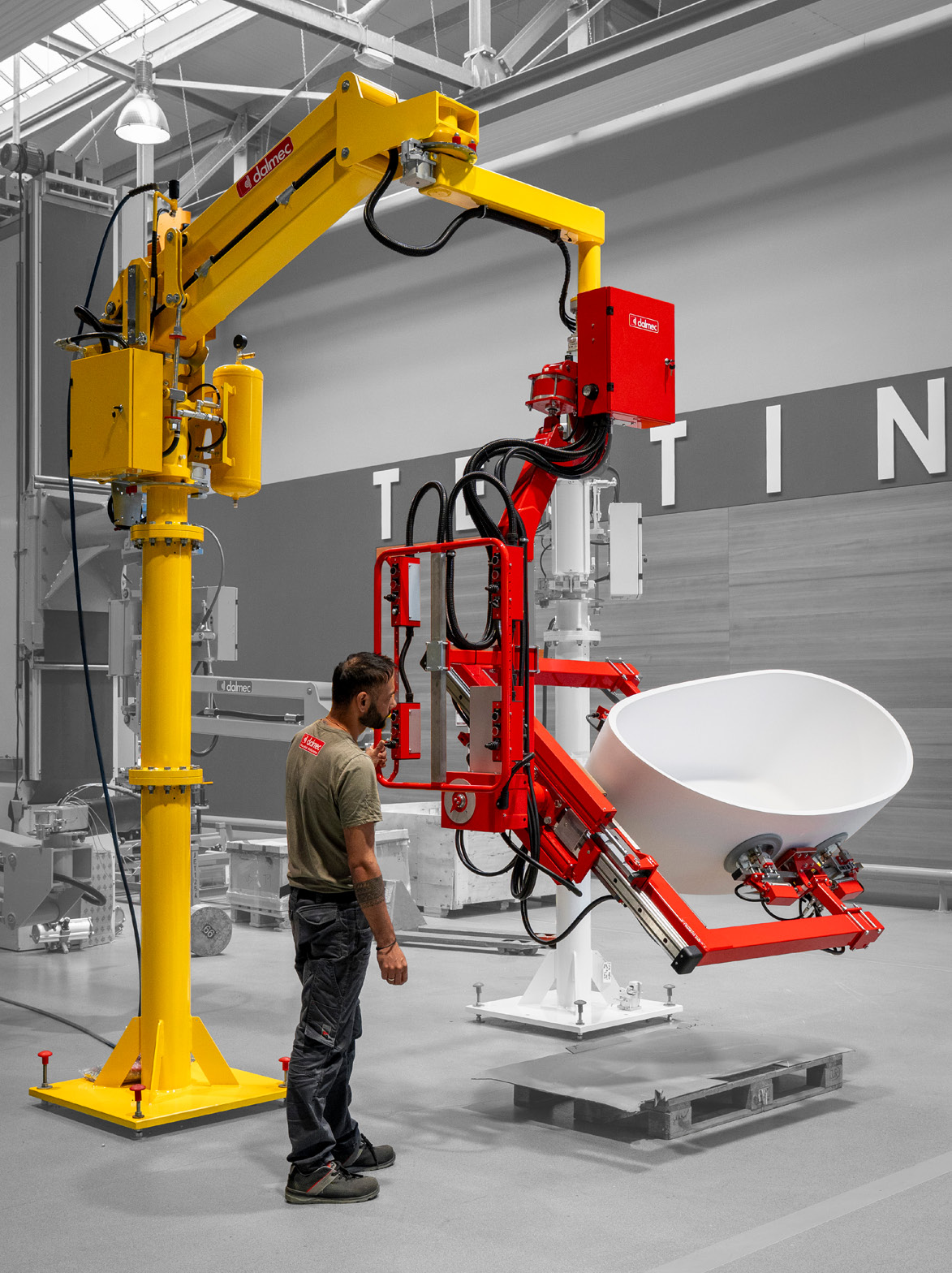 Dalmec manipulator tilting and positioning a bath tub using a custom gripping solution.