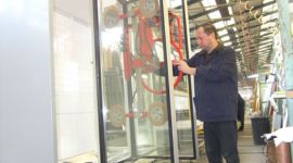 Dalmec manipulator safely lifting and positioning toughened glass window units during glass manufacturing.