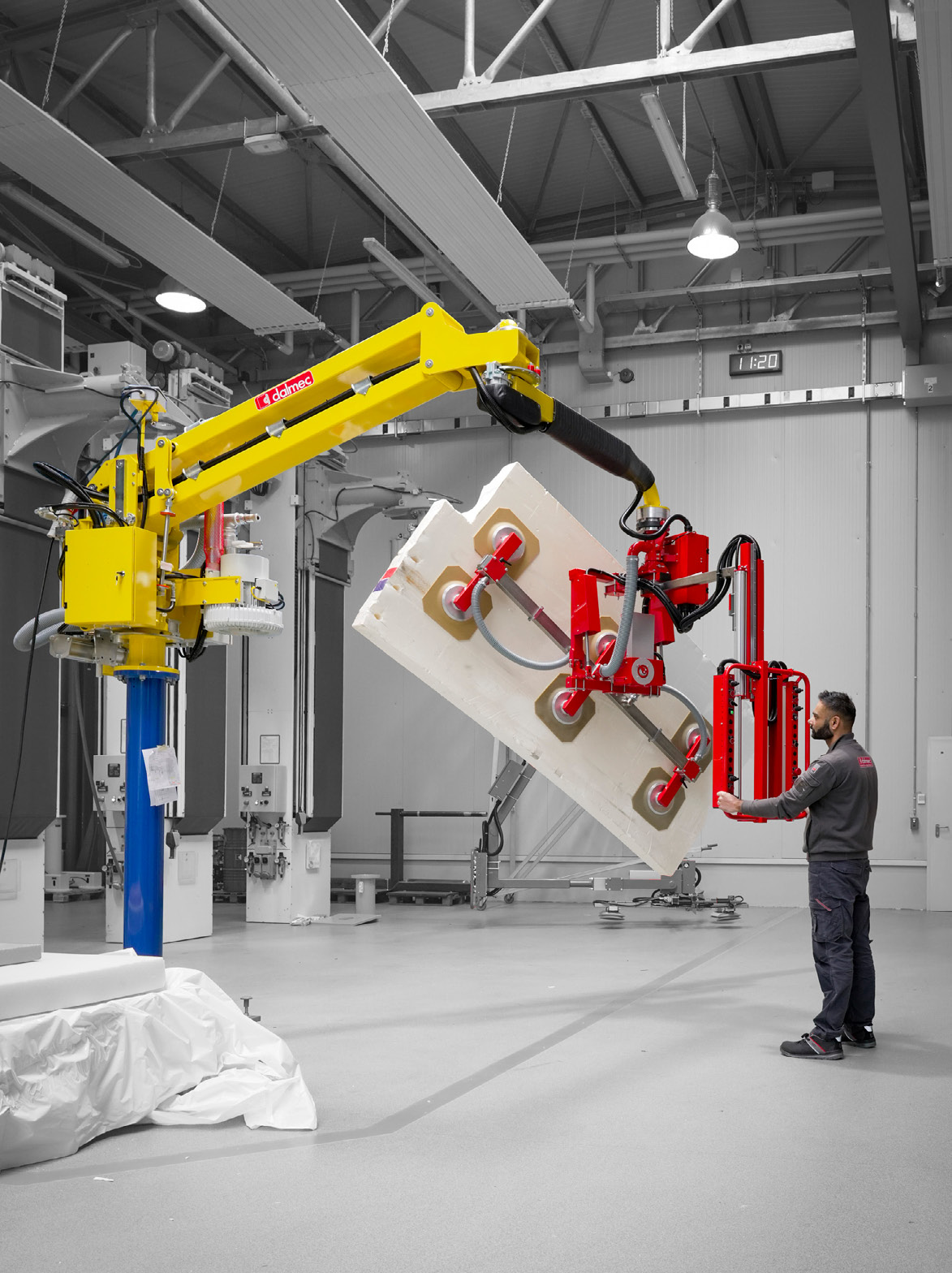 Dalmec vacuum manipulator handling a large industrial panel with precision and operator control.