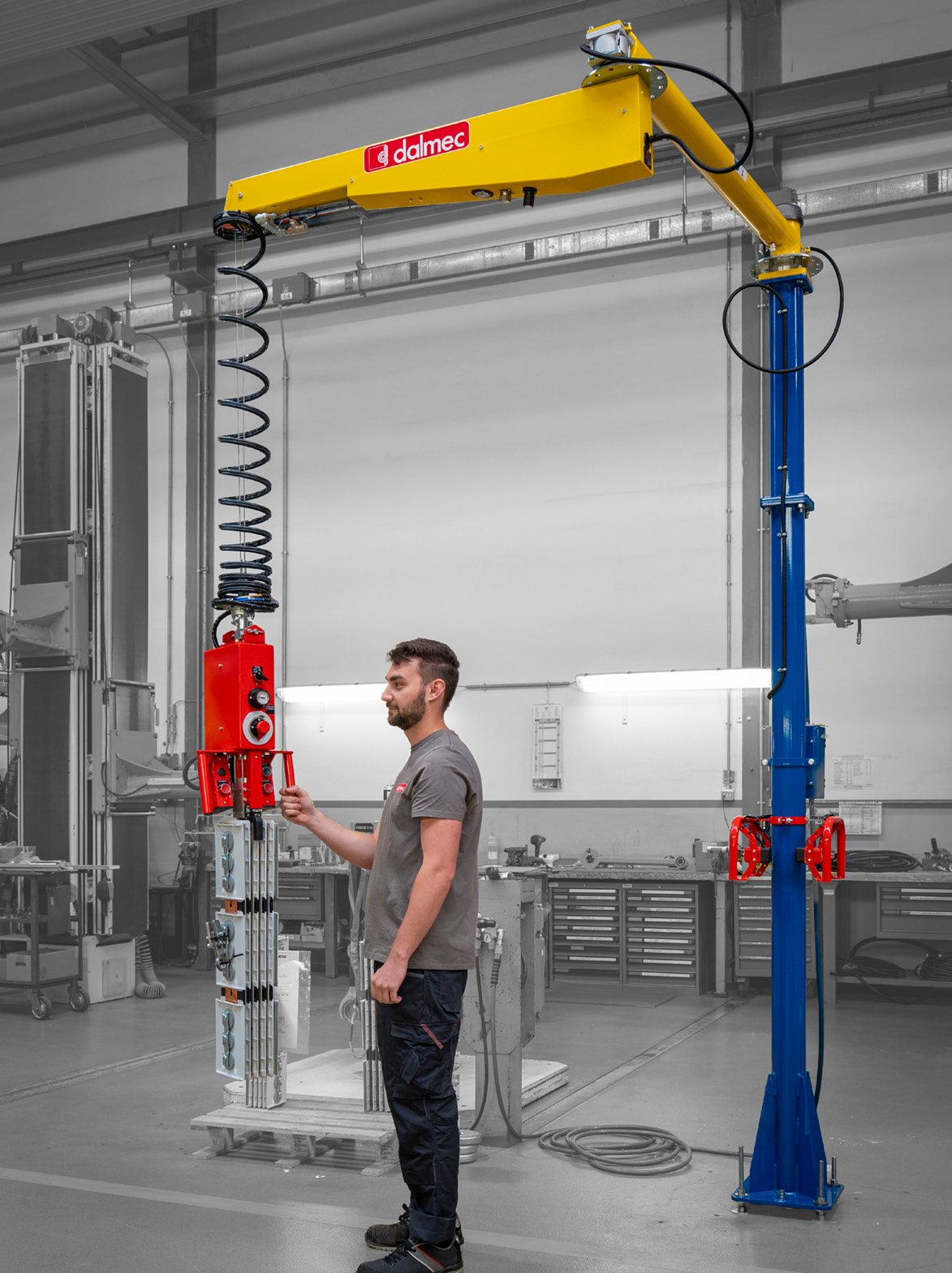 Dalmec vertical lifting manipulator transporting industrial panels with ergonomic assistance.