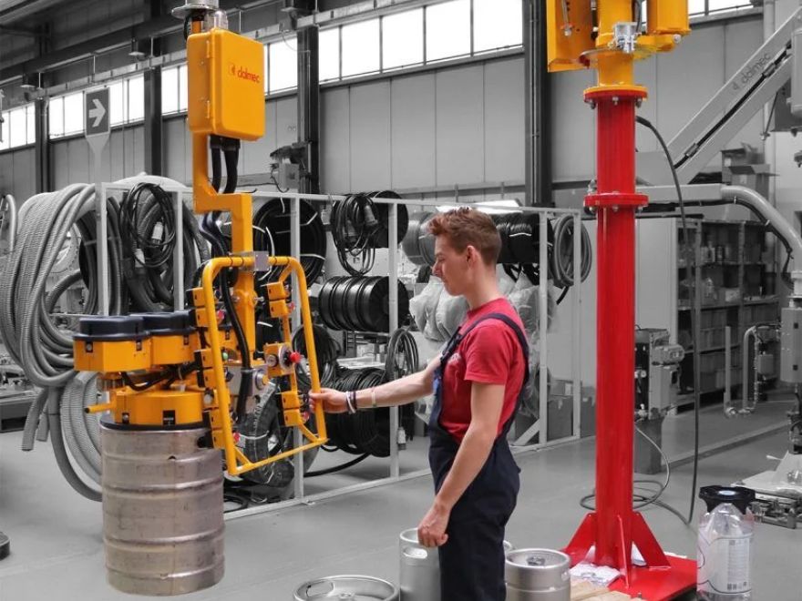 Dalmec manipulator safely lifting and positioning industrial waste containers for efficient material transfer.